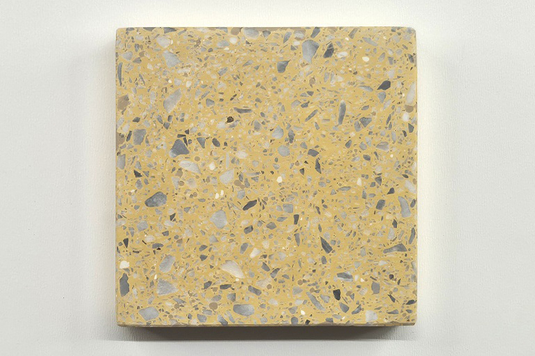 Geel terrazzo met Bardiglio marmer, waarbij de grijze natuursteen subtiel contrasteert met de gele basis.