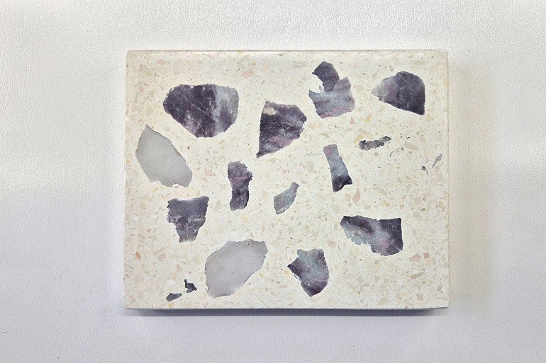 Lichte terrazzo met natuurlijke brokken roze toermalijn in roze, paarse en grijs-witte tinten.
