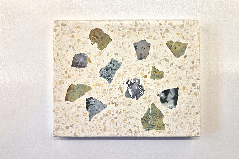 Lichte terrazzo met verschillende aangesneden brokken dendritisch gesteente. Lichte terrazzo met verschillende aangesneden brokken dendritisch gesteente.